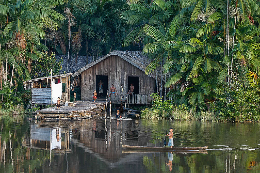 Amazonian family in front of their palafita home by the Mapuá River, at Estreito de Breves or Furos de Breves, Marajó region, Pará, Amazon, Brazil. May, 2004.